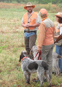 A judge reviews the course with two handlers on the line…