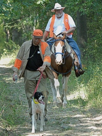 The course marshal follows a handler up to the line.